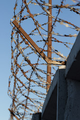 fence with barbed wire with blue sky background