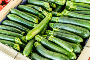 Zucchini or courgette in the wooden crate.