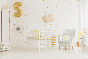 Golden balloon pinned to ladder