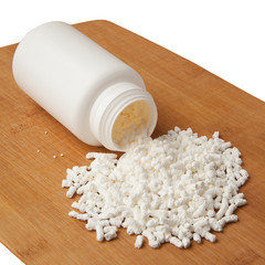 White plastic medical bottle whit medicine granules