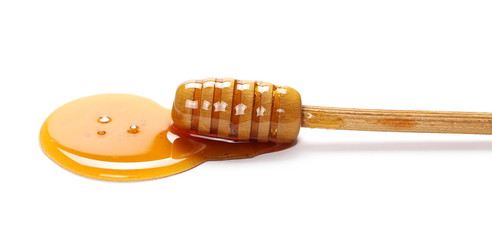 Honey and wooden dipper isolated on white background