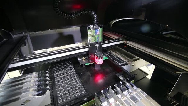 PCB processing on cnc machine production of electronic components at high tech factory. Microchip production factory technological process assembling the board chip manufacturing.