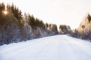 Winter road through the forest covered with snow