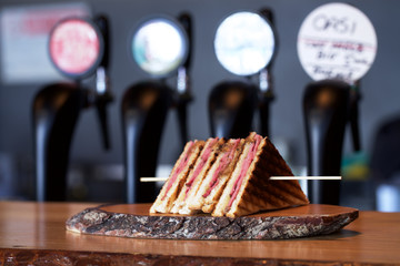 club sandwich on wood plate 