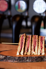 club sandwich on wood plate 