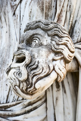 Fototapeta na wymiar A tragic mask in the hand of Statue of Melpomene, the muse of tragedy, on Achillion palace, Corfu Greece.