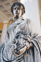 Statue of Melpomene, the muse of tragedy holding a tragic mask, on Achillion palace, Corfu Greece.