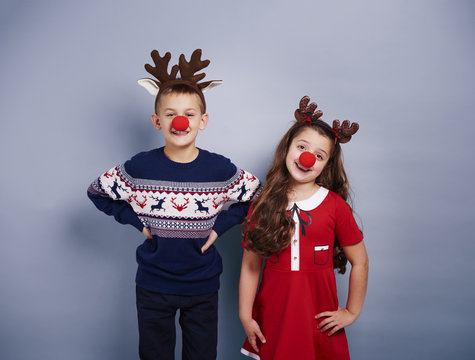 Cute girl and boy wearing reindeer costume