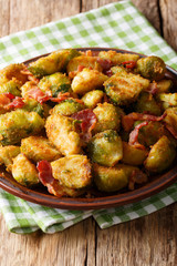 Organic food: fried Brussels sprouts in breadcrumbs with bacon close-up on. vertical