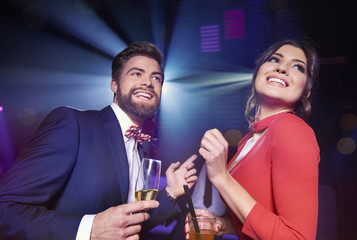 Cheerful couple with alcohol dancing