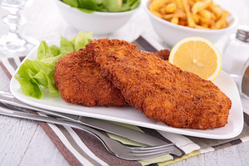 fried chicken with salad and french fries