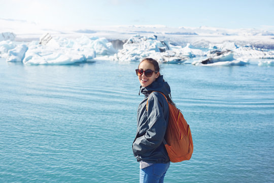 Woman with backpack in Ice Lagoon in Iceland