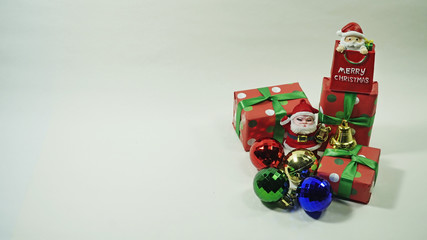 A glitter christmas decorations : santa claus, ornament, stars, drums and a present box on a white background with a copy space. Concept for Christmas celebrations.