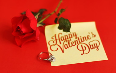 Red rose, ring and happy valentines day note