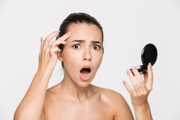Beauty portrait of an astonished attractive half naked woman