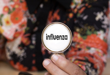 woman holding stethoscope with influenza text, concept influenza