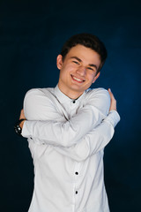 Fototapeta premium young brunette guy in a white shirt