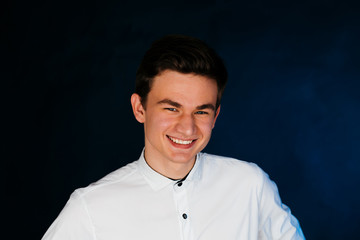 Fototapeta premium young brunette guy in a white shirt