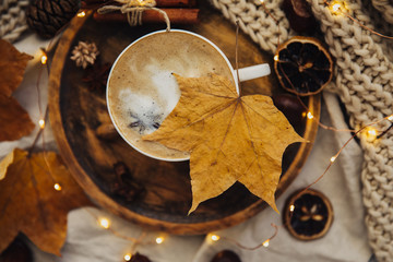 Autumn composition. Hot chocolate, knitted blanket, lit candle, autumn leaves. Flat lay, top view