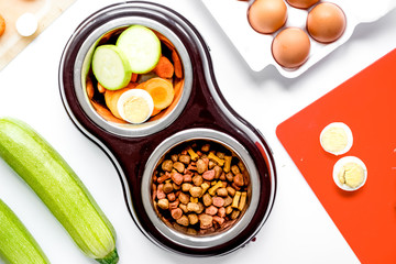petfood set with vegetables and eggs on kitchen table background