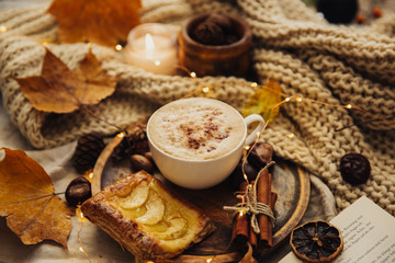 Autumn Cozy fall background with hot coffee cup and decorations. Hipster blogger morning