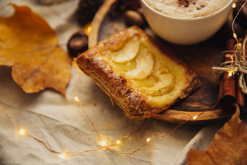 Autumn Cozy fall background with hot coffee cup and decorations. Hipster blogger morning