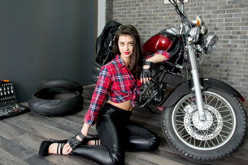 Fototapeta na wymiar portrait of a sexy girl at a motorcycle