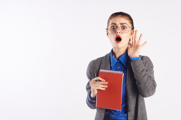 business woman with a notebook is trying to hear something