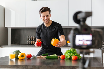 Cheerful young man filming his video blog