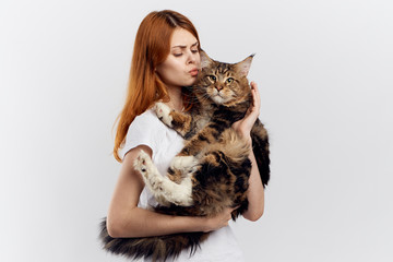 the girl is holding a fluffy cat