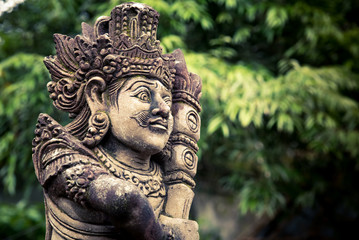 Fototapeta na wymiar Stone carved balinese statue