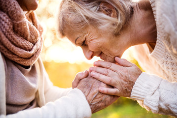 Senior women on a walk in autumn nature.