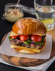 Burgers with meat, tomatoes, cheese and spinach.
