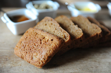 Fresh homemade unleavened bread on the leaven is sliced on a wooden board. Serving of breakfast