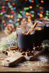 Christmas hot mulled wine with cinnamon cardamom and anise on wooden background, selective focus