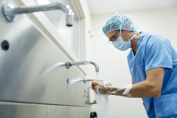 Surgeon washing hands before operation