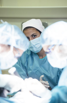 Woman working with surgeons