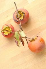 autumn vertical background with persimmon on wooden