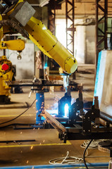 Welding robot in operation / Photo taken in Russia, in factory premises