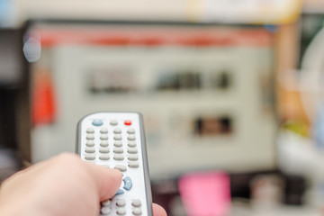 man watching tv and using remote controller