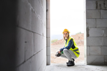 Young woman worker on the construction site.