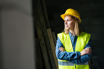 Young woman worker on the construction site.