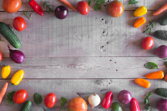 Fresh organic vegetables on a wooden background. Top view