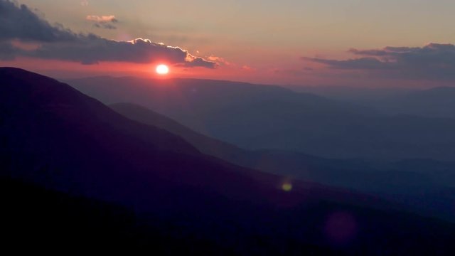 Sunset over mountains. Beautiful sky colours. Timelapse.