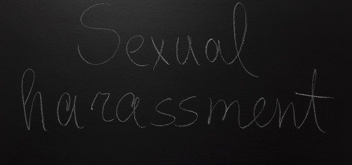Fototapeta na wymiar written text on blackboard: Sexual harassment