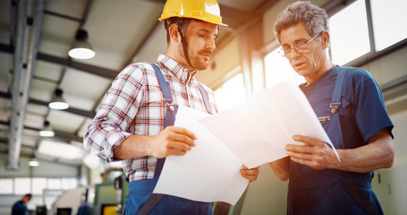 Team Of Engineers Having Discussion In Factory