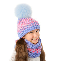 Beautiful little girl in winter warm hat and scarf isolated on white. Children winter clothes