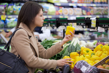 young woman buying at supermarket