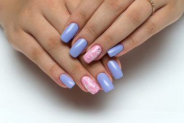 Obraz na płótnie Canvas Delicate violet, pink manicure with white flowers and crystals on long square nails 
