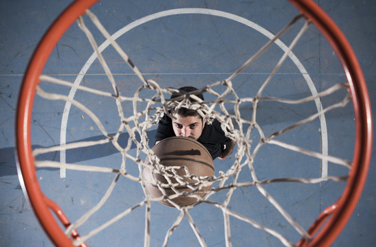 Man catching ball under hoop